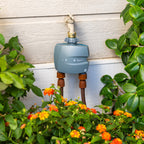 Watering system with garden hose and plants in a garden setting