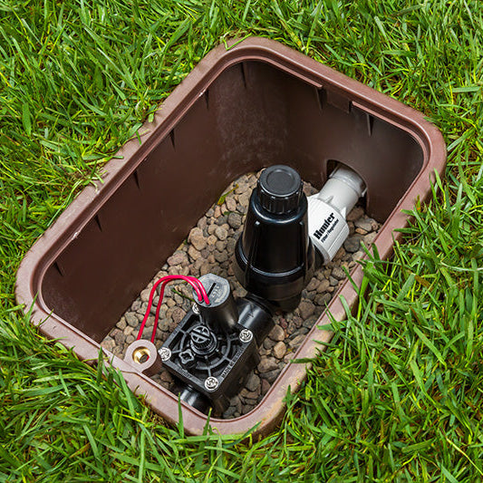 Outdoor irrigation valve box on grass