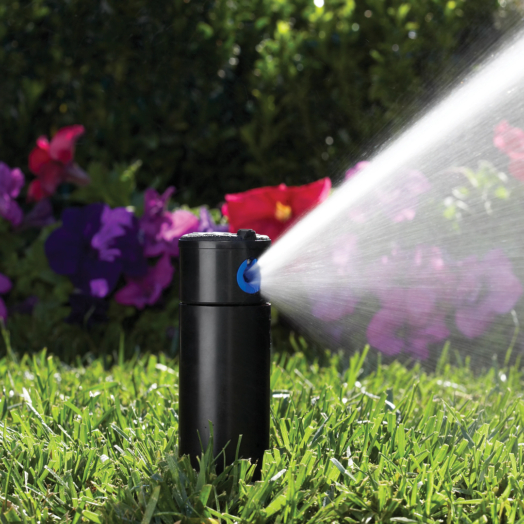 Hunter PGP adjustable 4-inch rotor sprinkler installation photo spraying water over lawn 
