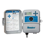 Hunter X2 WiFi compatible irrigation controller with blue control panel, LCD screen, and instruction label inside open gray.