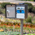 Control panel on a stand with a garden in the background